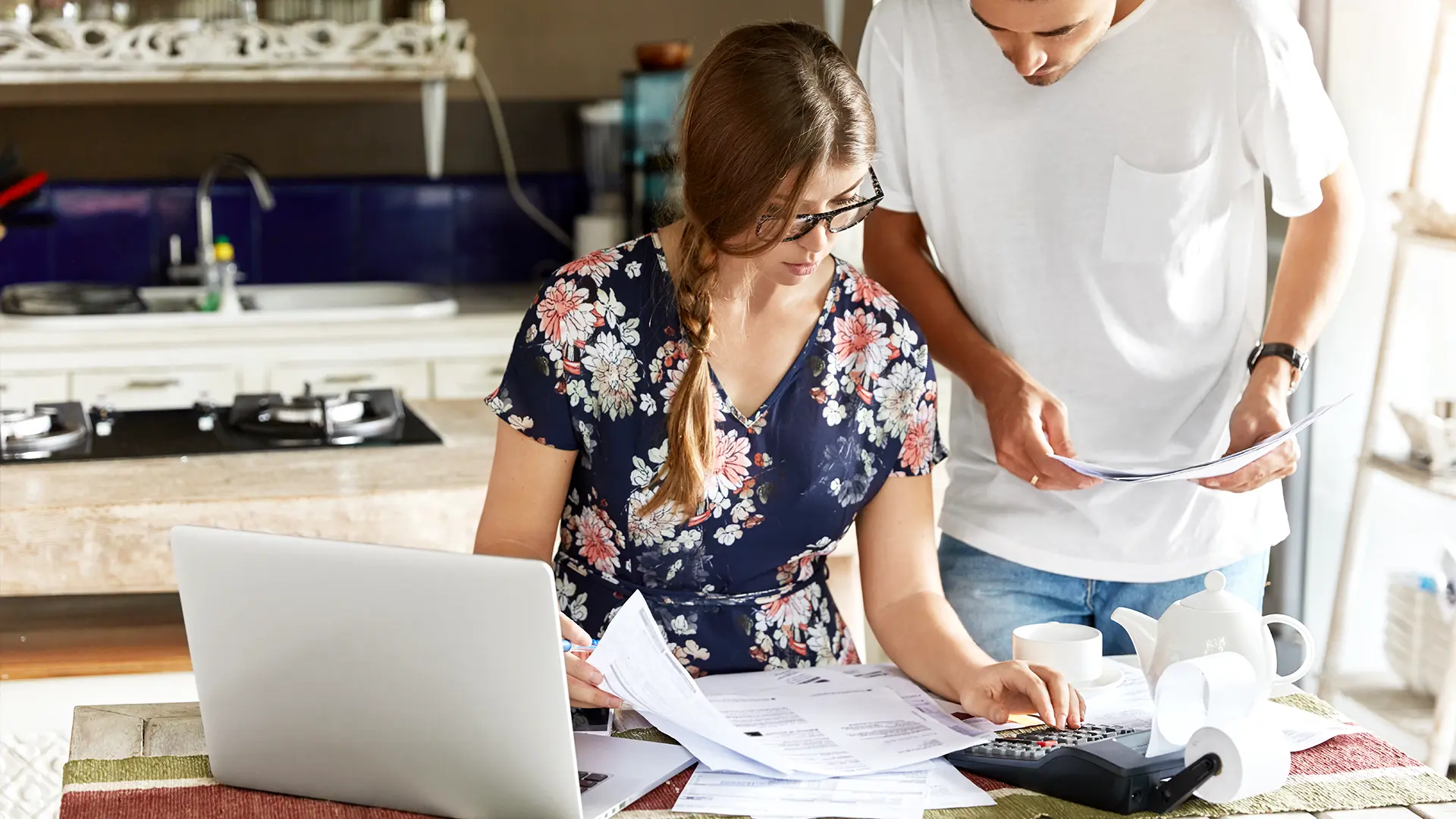 Couple working on laptop to work out price of home extension