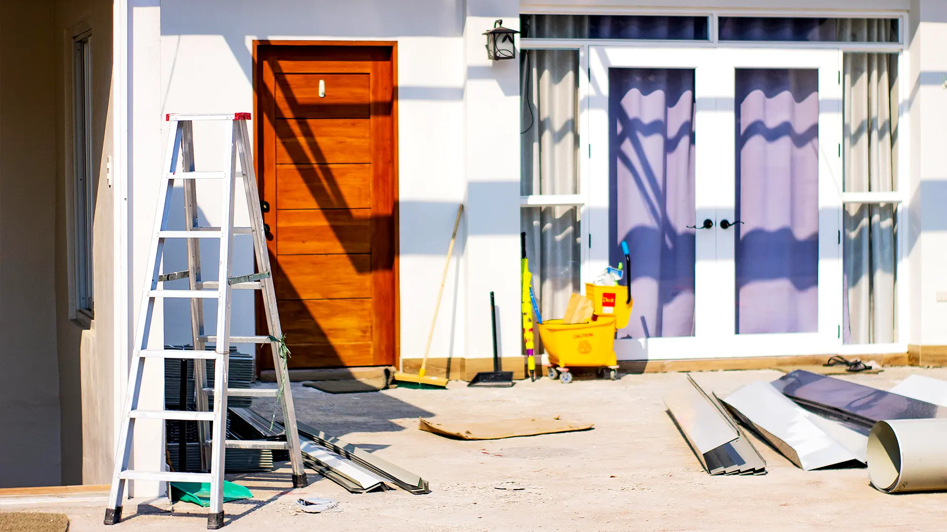 Front of a house getting renovated, ladder and tools